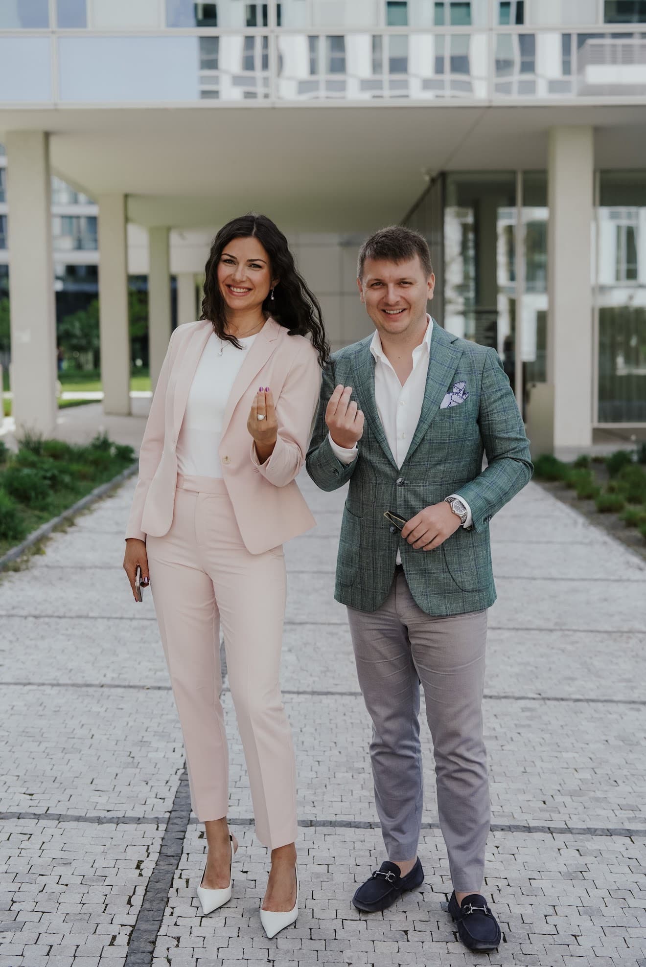 Kristina with a man outside an apartment building